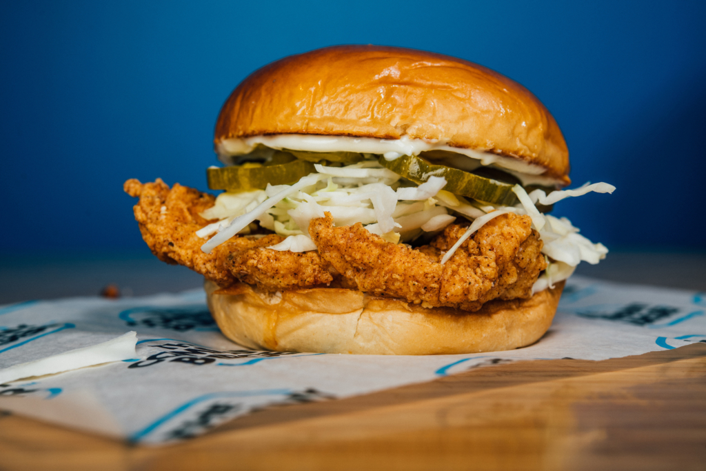 The Company Burger Fried Chicken Sandwich with pickles and slaw.